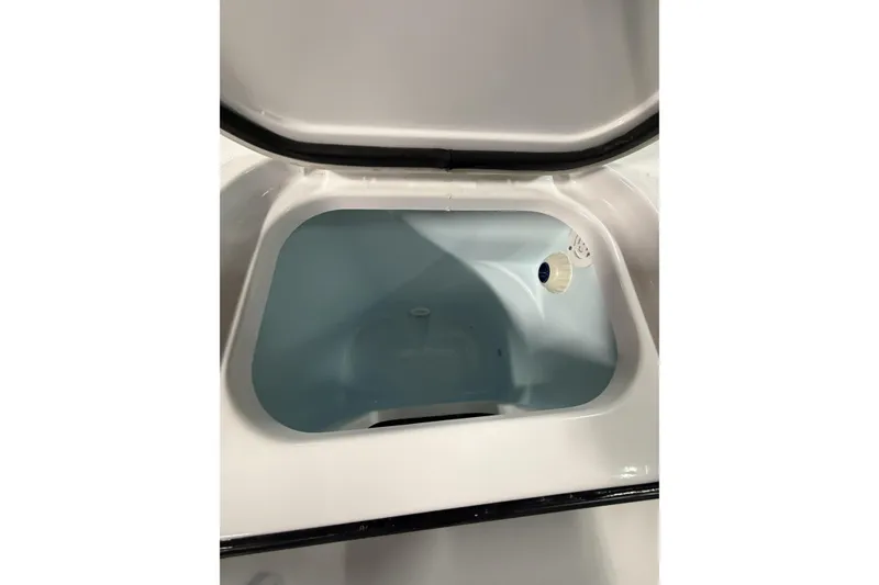 Slide: The Image of 2026 Sportsman Open 232 Center Console storage compartment interior view. - 32