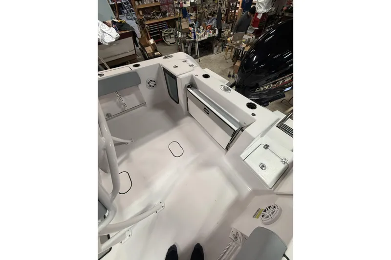 Slide: The Image of 2026 Sportsman Open 232 Center Console boat interior with storage compartments and seating. - 34