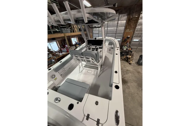 Slide: The Image of 2026 Sportsman Open 232 Center Console boat in a garage, showcasing interior layout. - 35