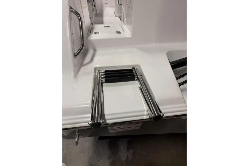 Slide: The Image of 2026 Sportsman Open 232 Center Console boat with stainless steel swim ladder. - 38