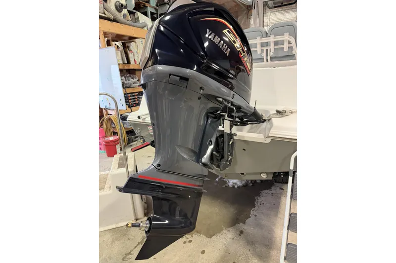 Slide: The Image of Yamaha outboard motor on 2026 Sportsman Open 232 Center Console boat in garage. - 39
