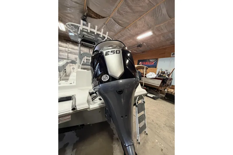 Slide: The Image of 2026 Sportsman Open 232 Center Console with powerful 250 horsepower engine in a garage setting. - 40