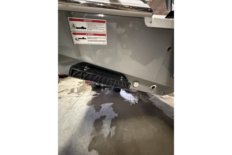 Slide: The Image of 2026 Sportsman Open 232 Center Console boat hull with warning labels and drainage ports. - 41