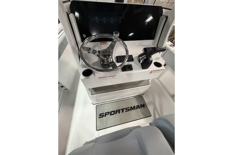 Slide: The Image of 2026 Sportsman Open 232 Center Console boat dashboard with steering wheel and controls. - 7