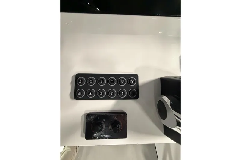 Slide: The Image of Control panel of 2026 Sportsman Open 232 Center Console boat with Yamaha controls. - 8