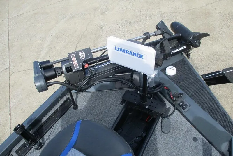 Slide: The Image of 2023 Ranger RT178 boat interior with blue and gray seating, steering console, and carpeted deck. - 6