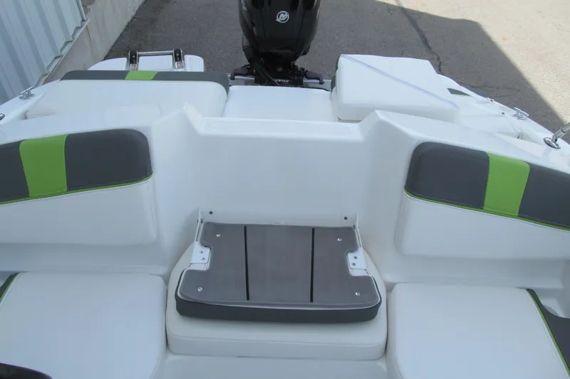 Slide: The Image of 2022 Tahoe T16 boat interior with white and green seating, rear view. - 10