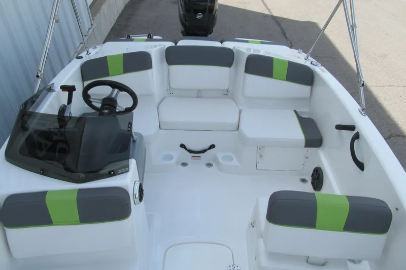 Slide: The Image of 2022 Tahoe T16 boat interior with gray and green seating, steering wheel, and console. - 11