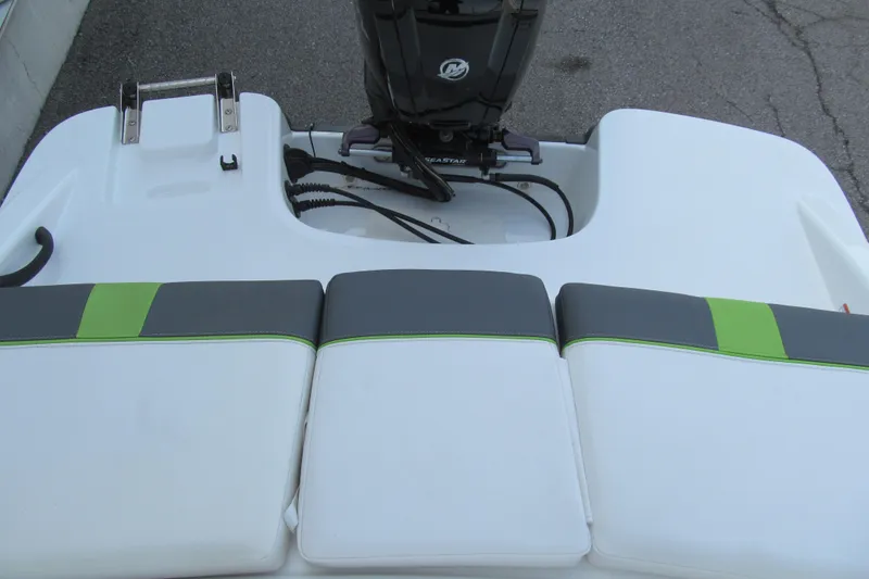 Slide: The Image of 2022 Tahoe T16 boat with green and gray seating, featuring an outboard motor. - 13