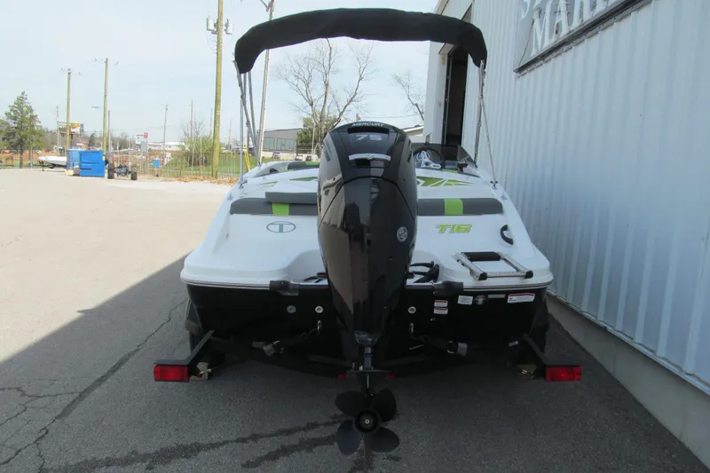 Slide: The Image of 2022 Tahoe T16 boat with Mercury 75 engine, parked outdoors. - 3
