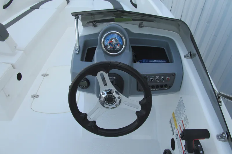 Slide: The Image of 2022 Tahoe T16 boat dashboard with steering wheel and control panel. - 5