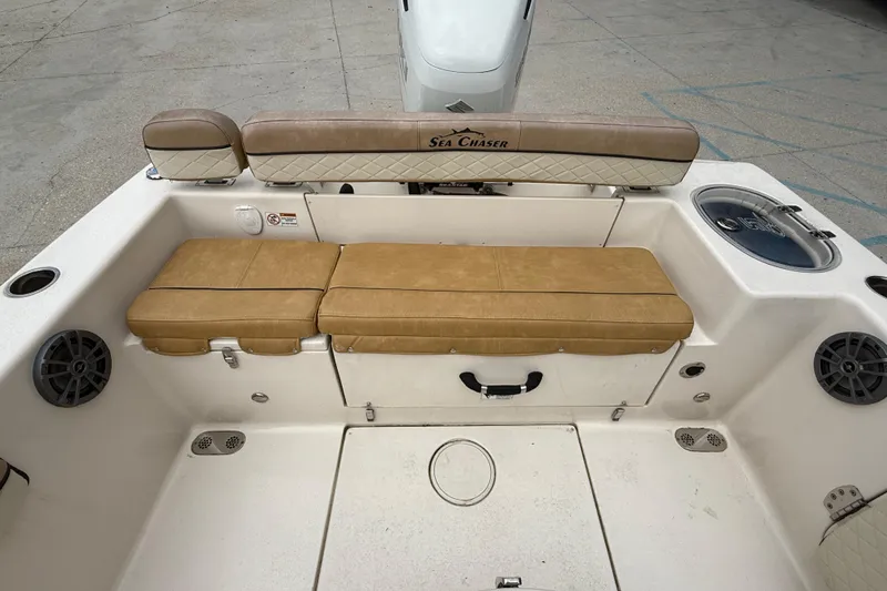 Slide: The Image of 2023 SeaChaser 24 HFC boat interior with tan seating and storage compartments. - 12