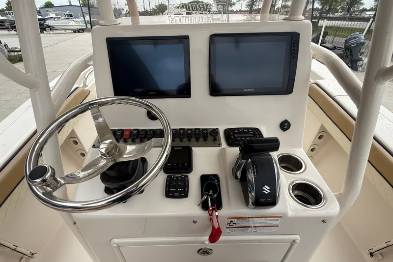 Slide: The Image of 2023 SeaChaser 24 HFC boat console with dual screens, steering wheel, and controls. - 13
