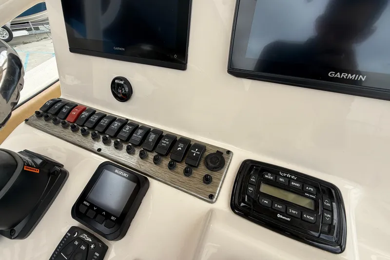 Slide: The Image of Control panel of 2023 SeaChaser 24 HFC boat with Garmin displays and switches. - 14