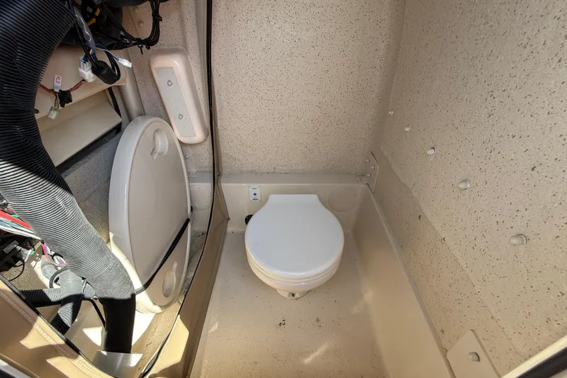 Slide: The Image of 2023 SeaChaser 24 HFC boat interior with compact marine toilet. - 17