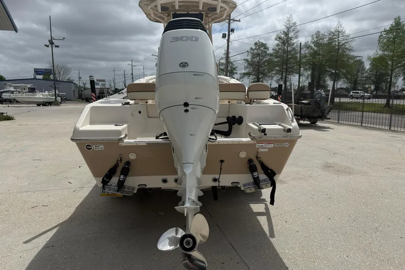Slide: The Image of 2023 SeaChaser 24 HFC boat with powerful outboard motor, parked on concrete surface. - 5