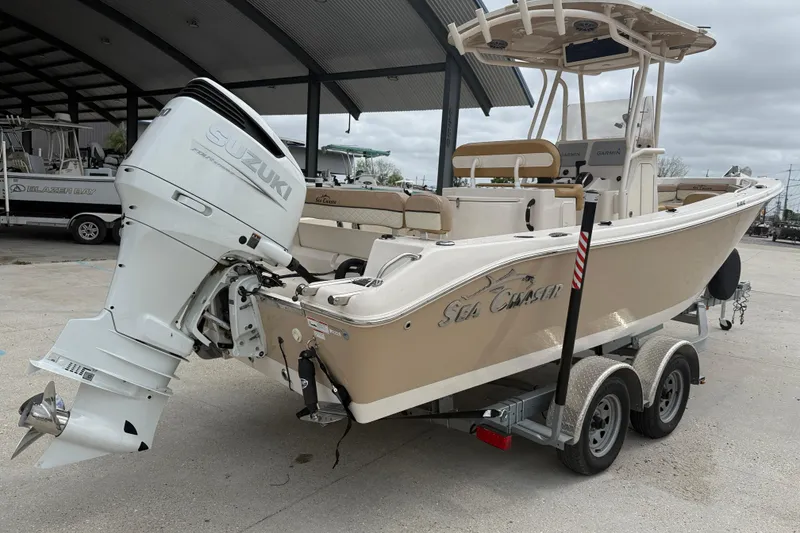 Slide: The Image of 2023 SeaChaser 24 HFC boat with Suzuki outboard motor on a trailer. - 6