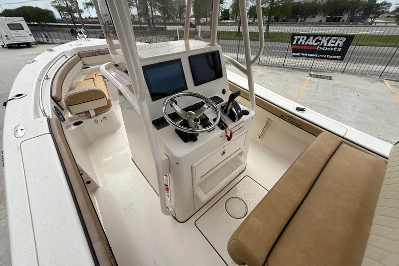 Slide: The Image of 2023 SeaChaser 24 HFC boat interior with dual screens and beige seating. - 8