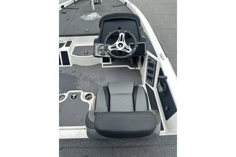 Slide: The Image of 2021 Caymas CX 19 boat interior with steering wheel and seating. - 11
