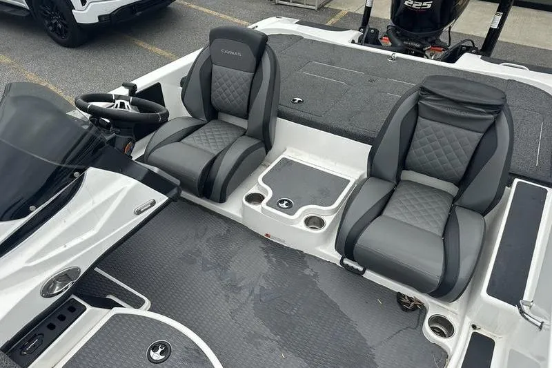 Slide: The Image of 2021 Caymas CX 19 boat interior with dual gray seats and steering wheel. - 12