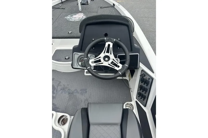 Slide: The Image of 2021 Caymas CX 19 boat cockpit with steering wheel and control panel. - 14