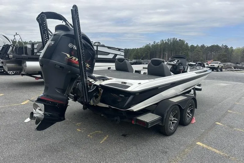Slide: The Image of 2021 Caymas CX 19 boat with Yamaha engine on trailer in parking lot. - 3