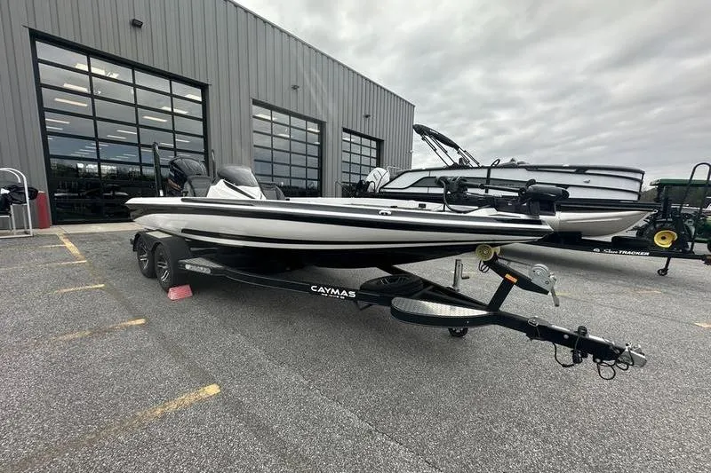Slide: The Image of 2021 Caymas CX 19 boat on trailer outside a showroom. - 8