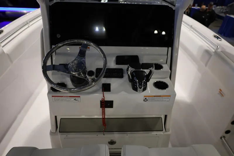 Slide: The Image of 2026 Sportsman Open 252 Center Console boat dashboard with steering wheel and controls. - 11