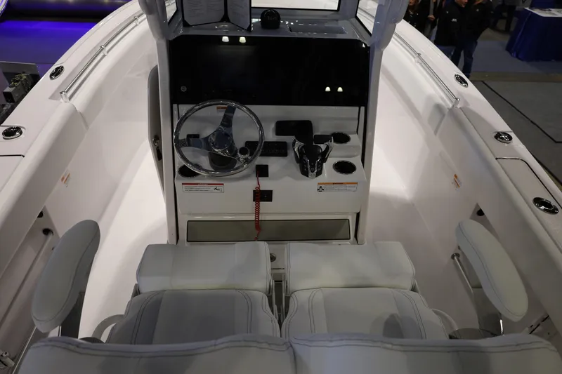 Slide: The Image of 2026 Sportsman Open 252 Center Console boat interior with steering wheel and seating. - 12