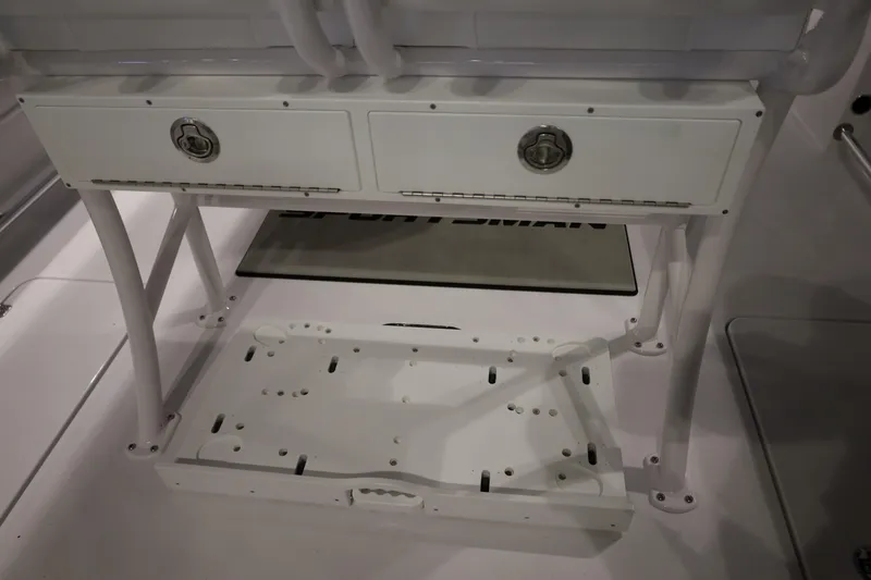 Slide: The Image of 2026 Sportsman Open 252 Center Console storage compartment with dual drawers and sturdy frame. - 16