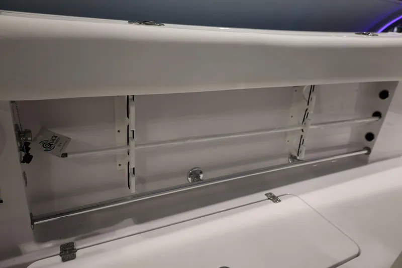 Slide: The Image of 2026 Sportsman Open 252 Center Console storage compartment with sleek design and organized shelving. - 19