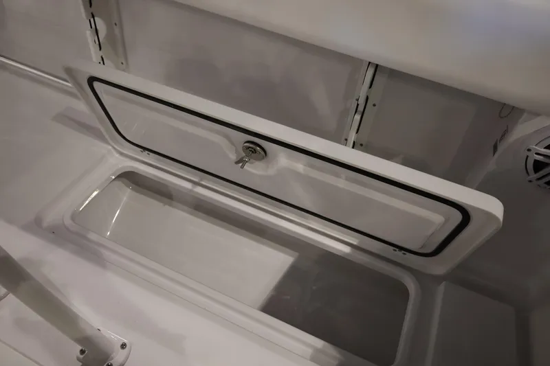 Slide: The Image of 2026 Sportsman Open 252 Center Console storage compartment with secure latch. - 22