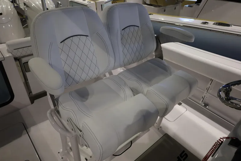 Slide: The Image of 2026 Sportsman Open 252 Center Console boat seats with diamond stitching and armrests. - 23