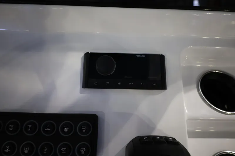 Slide: The Image of Control panel of 2026 Sportsman Open 252 Center Console boat with Fusion audio system. - 25