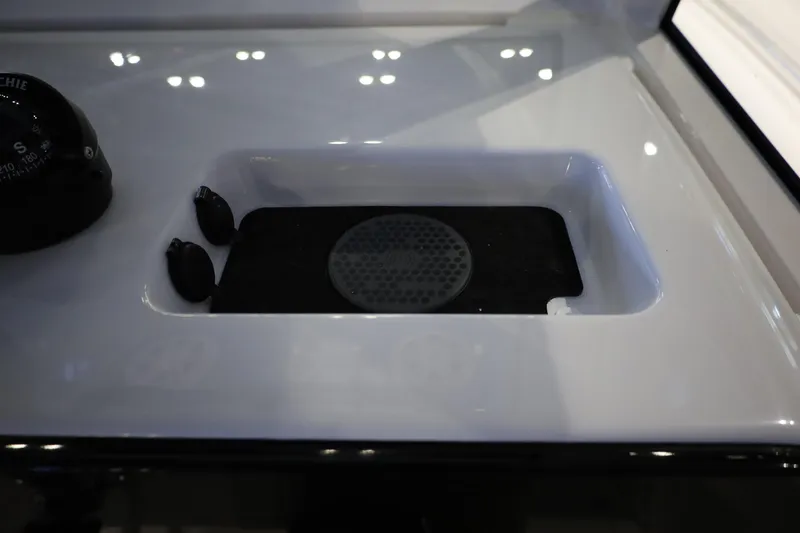 Slide: The Image of 2026 Sportsman Open 252 Center Console dashboard with compass and storage compartment. - 27