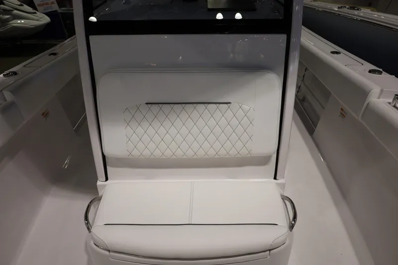 Slide: The Image of 2026 Sportsman Open 252 Center Console boat interior with white cushioned seating. - 32