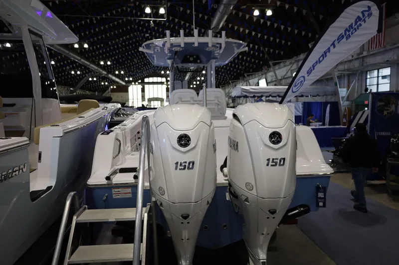 Slide: The Image of 2026 Sportsman Open 252 Center Console boat with twin Yamaha 150 engines at indoor exhibit. - 5