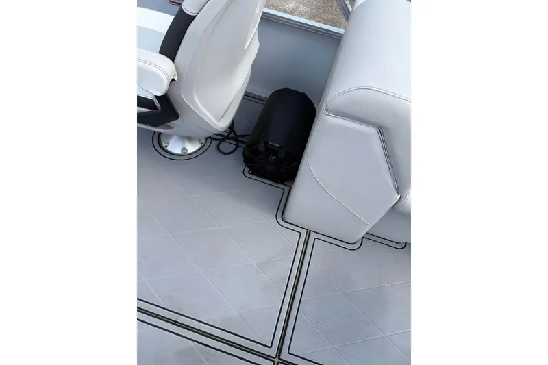 Slide: The Image of Interior of 2023 Avalon Venture 85 Quad Lounge with white seating and flooring. - 4