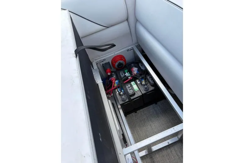 Slide: The Image of 2023 Avalon Venture 85 Quad Lounge battery compartment with wiring and components. - 5