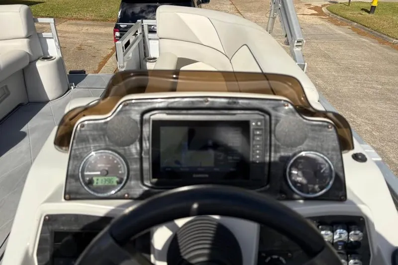 Slide: The Image of 2023 Avalon Venture 85 Quad Lounge dashboard with modern controls and comfortable seating. - 6