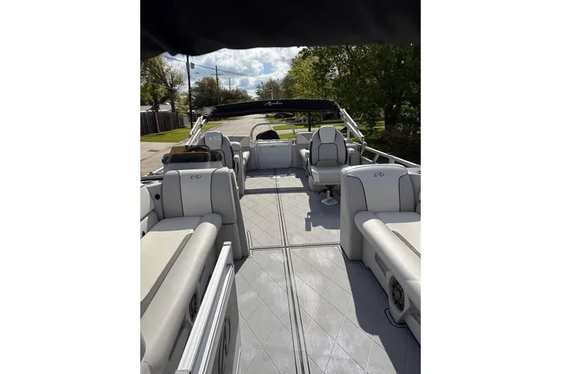 Slide: The Image of 2023 Avalon Venture 85 Quad Lounge pontoon boat with spacious seating and modern design. - 8