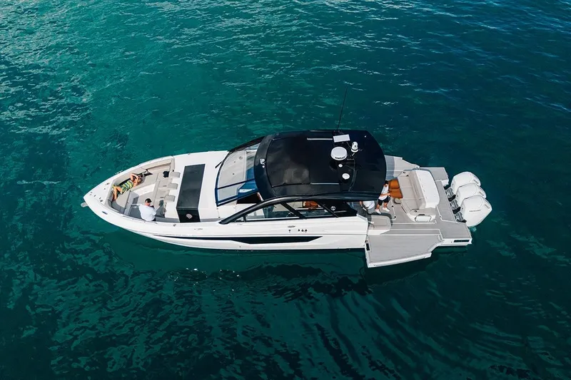 The Image of 2024 Cruisers Yachts 50 GLS on clear blue water, aerial view. - 1