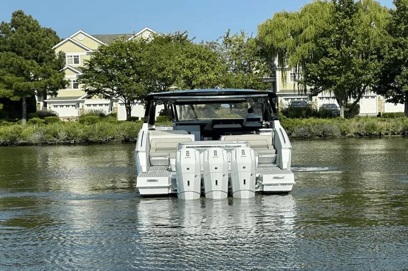 Slide: The Image of 2024 Cruisers Yachts 50 GLS on water, showcasing triple outboard engines. - 11