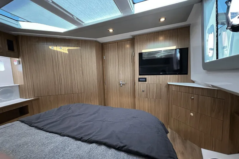 Slide: The Image of Luxurious interior of 2024 Cruisers Yachts 50 GLS with wood paneling and modern amenities. - 15