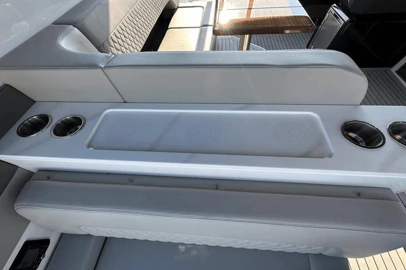 Slide: The Image of Luxurious seating area on 2024 Cruisers Yachts 50 GLS with cup holders and wireless charging. - 17