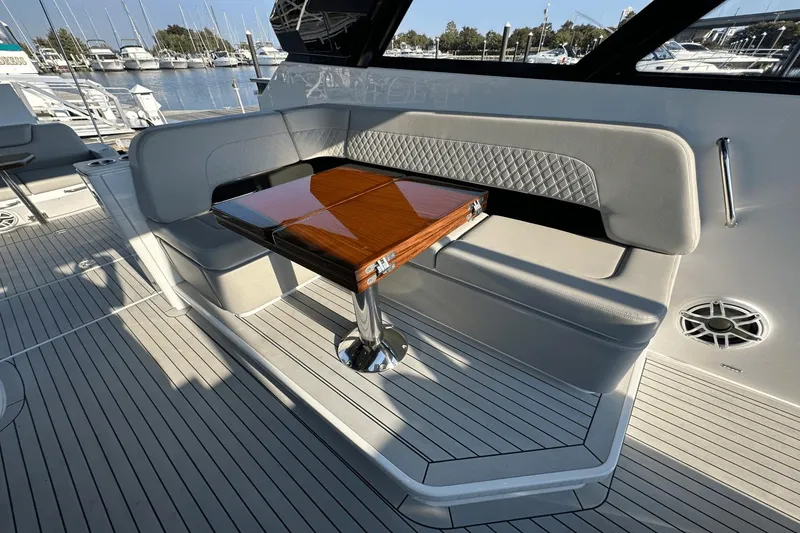 Slide: The Image of Luxurious seating area on 2024 Cruisers Yachts 50 GLS with elegant wooden table. - 20