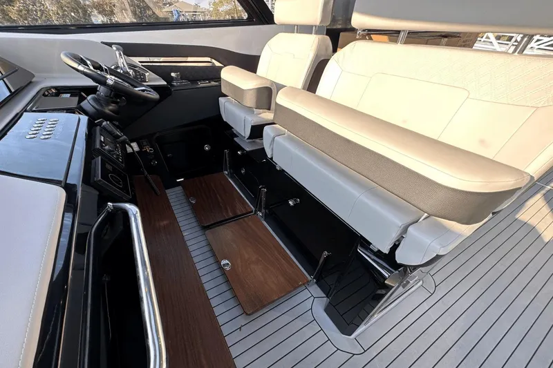 Slide: The Image of 2024 Cruisers Yachts 50 GLS helm with luxurious seating and modern controls. - 21