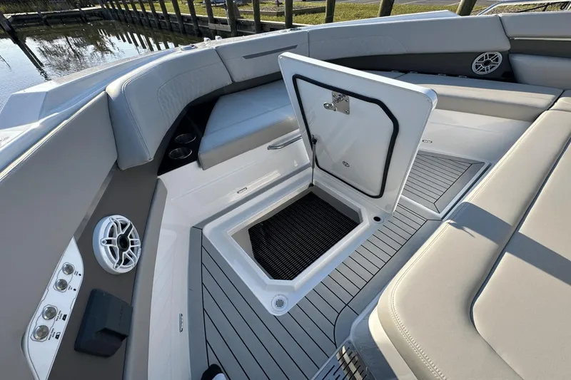 Slide: The Image of 2024 Cruisers Yachts 50 GLS interior with open storage compartment and seating area. - 24