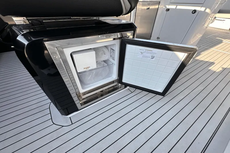 Slide: The Image of Open refrigerator on 2024 Cruisers Yachts 50 GLS, showcasing sleek interior design. - 25