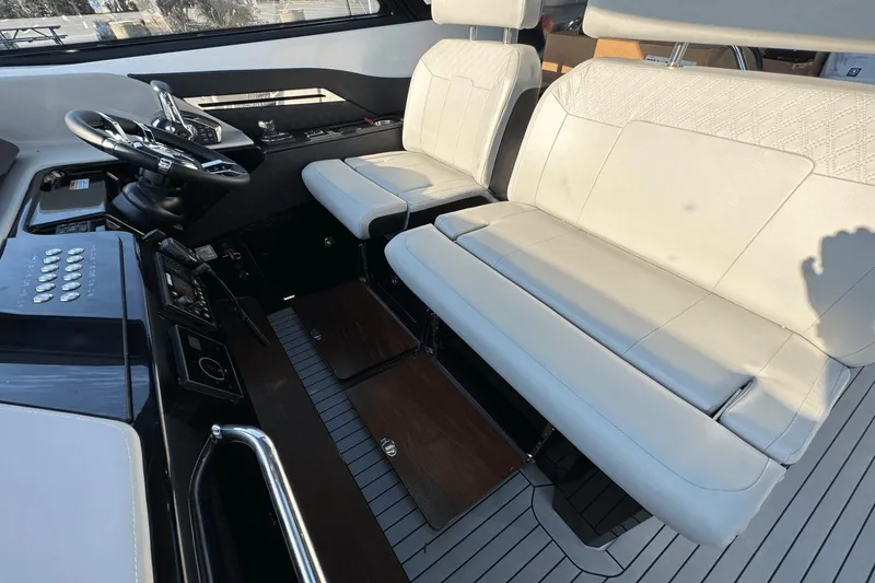 Slide: The Image of 2024 Cruisers Yachts 50 GLS helm with luxurious seating and modern controls. - 26